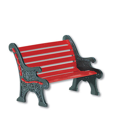 Village red wrought iron park bench